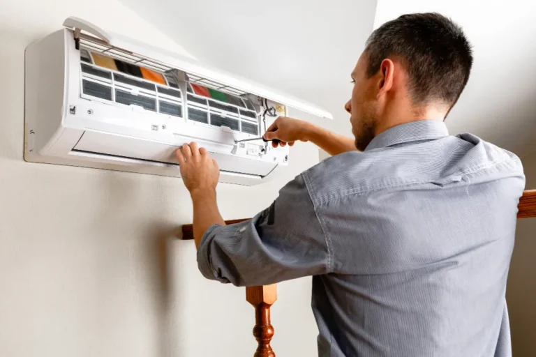 AC maintenance schedule in UAE with technician servicing a split air conditioner